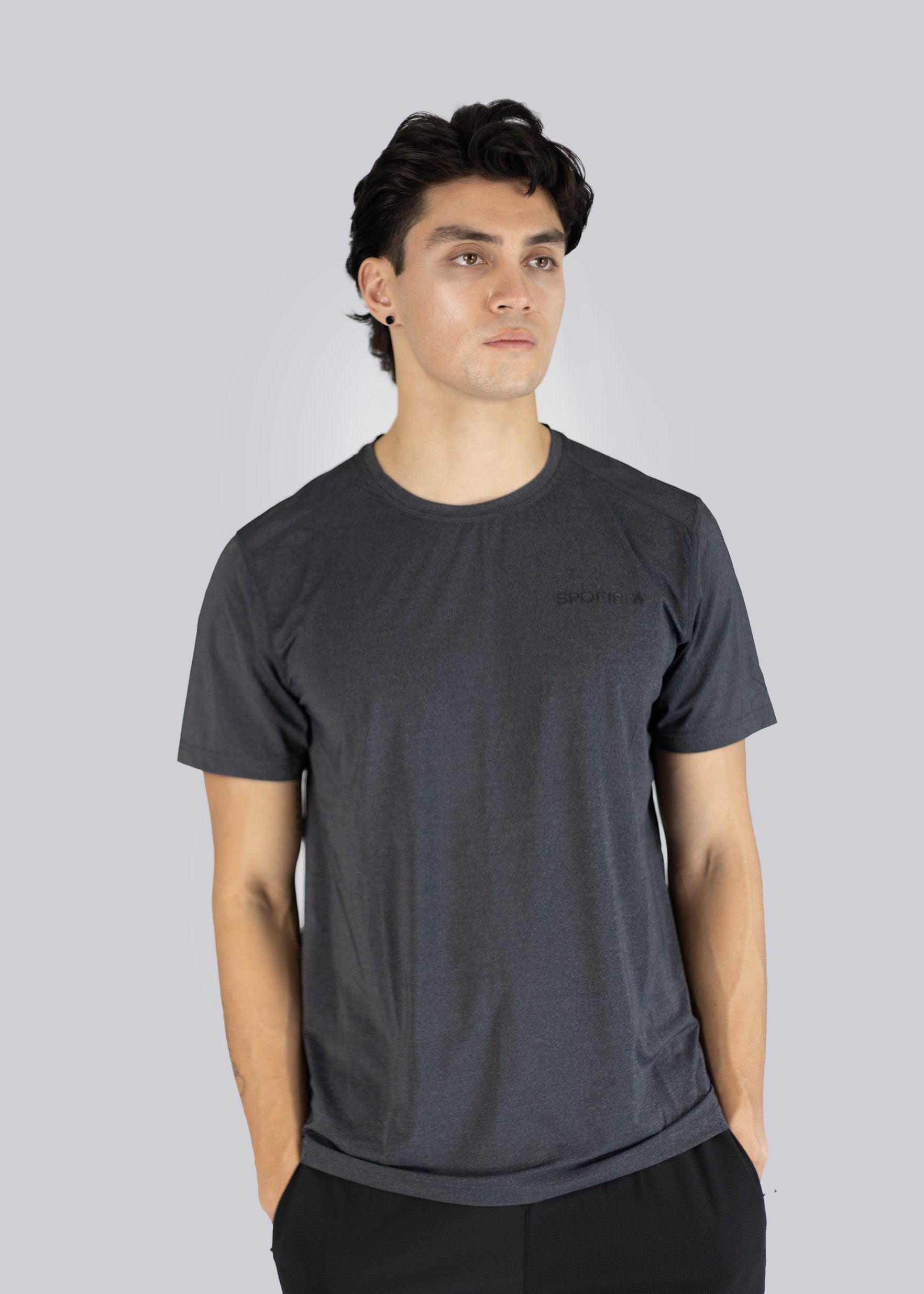 A man wearing a dark gray t-shirt with S pofire logo on a light gray background