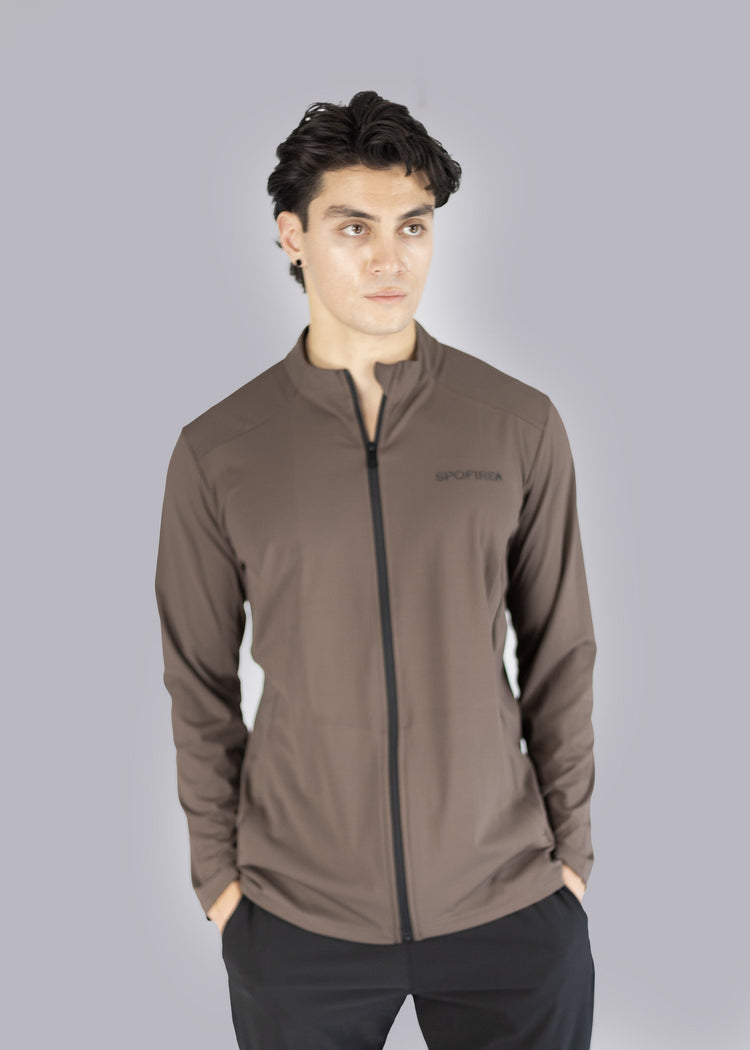 Man wearing a brown jacket with a Spofire logo on a gray background