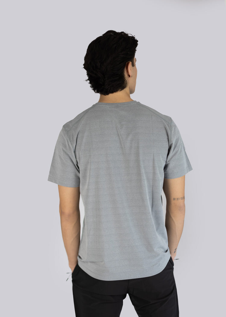 Person wearing a gray t-shirt against a plain background back side photo