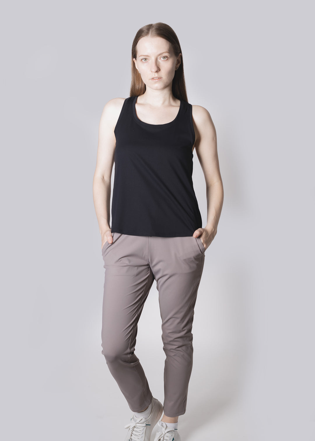 Woman wearing a black tank top and Rose Pink on a white background