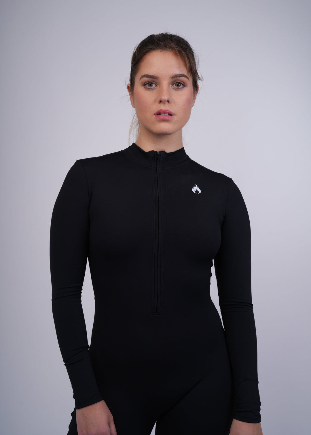 A model wearing a black long-sleeve athletic outfit with the Spofire  logo on a gray background