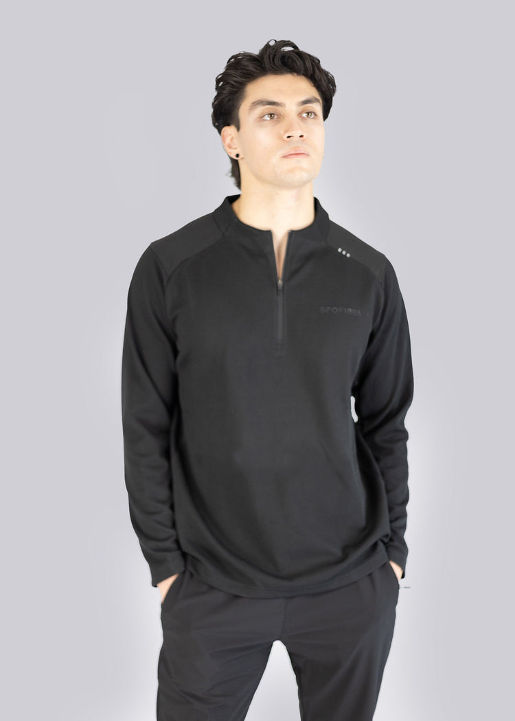 A Man wearing a black sweater with the Spofire logo on a gray background