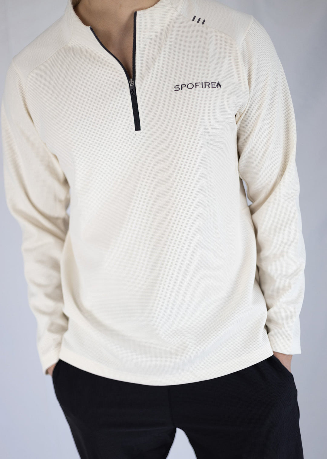 White long-sleeve shirt with a zipper and 'SPOFIRE' branding on a plain background
