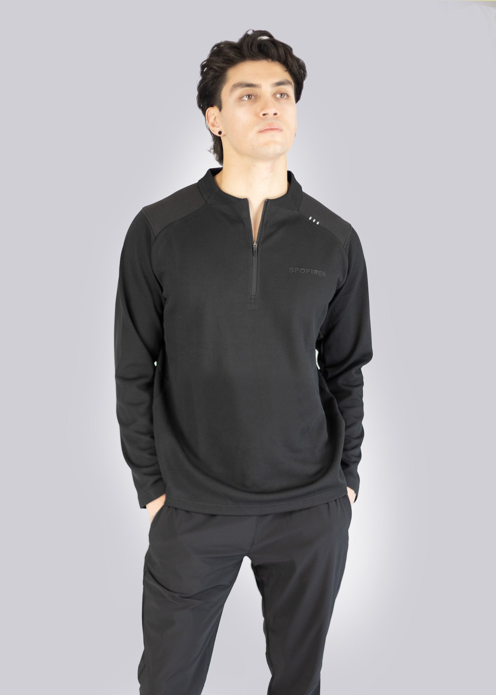 Man wearing a black Sweater with a zipper on a gray background